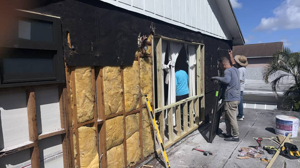 Crew preparing window openings and framing