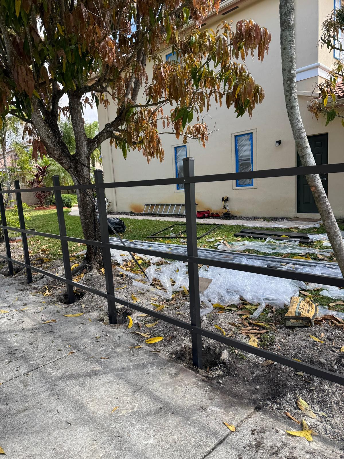 Fence frame beside a sidewalk during installation