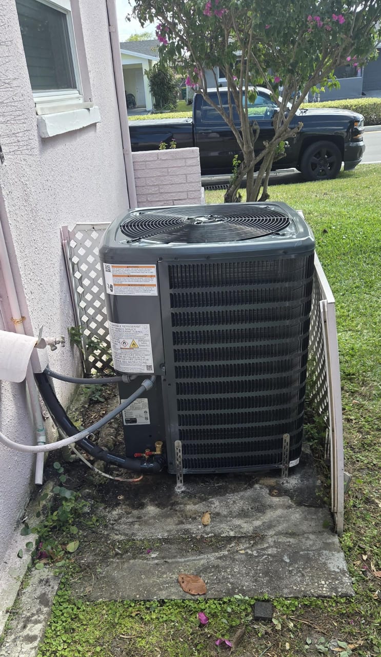 Outdoor condenser unit installed beside a home