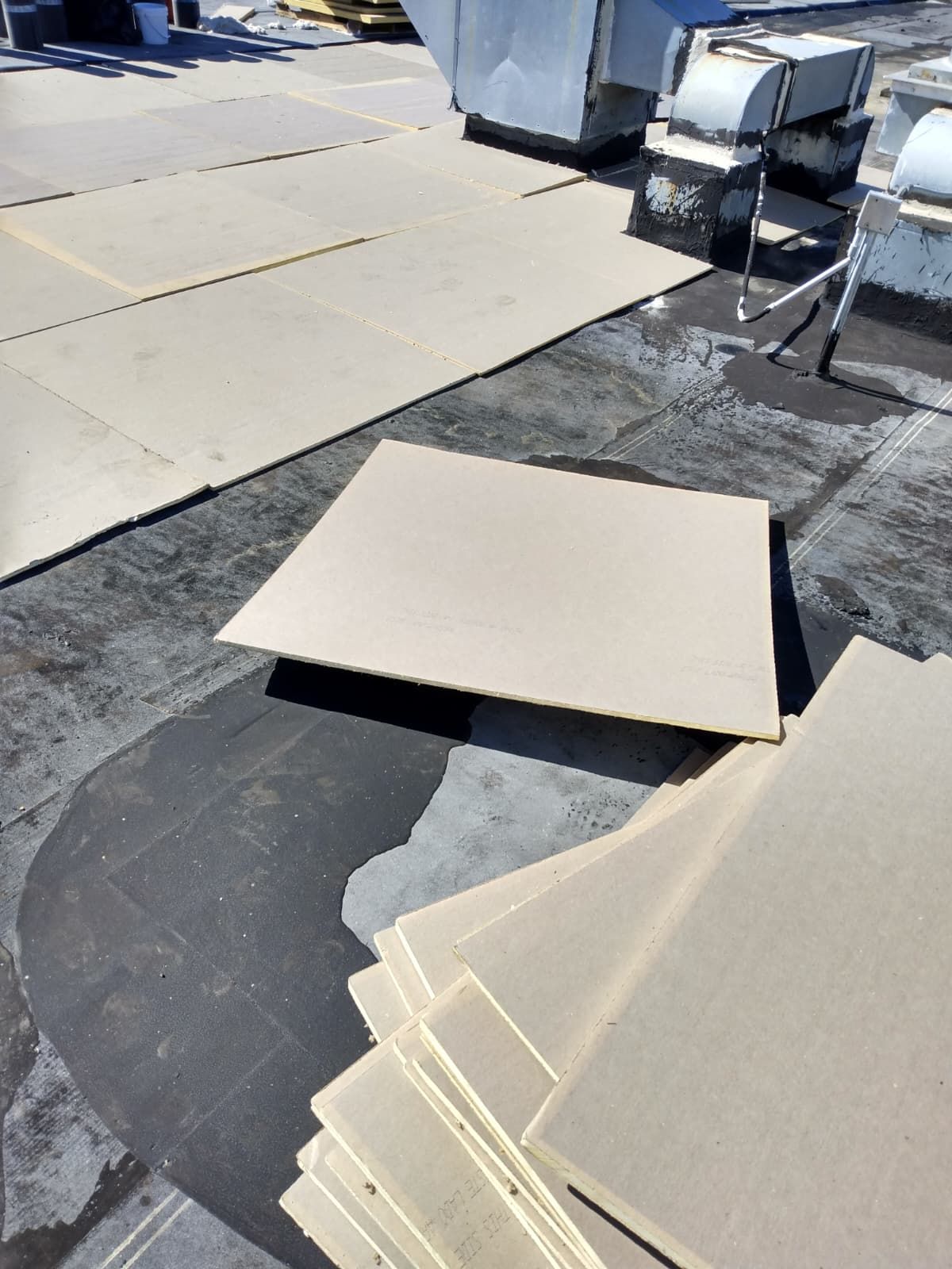 Insulation board installation on a flat roof