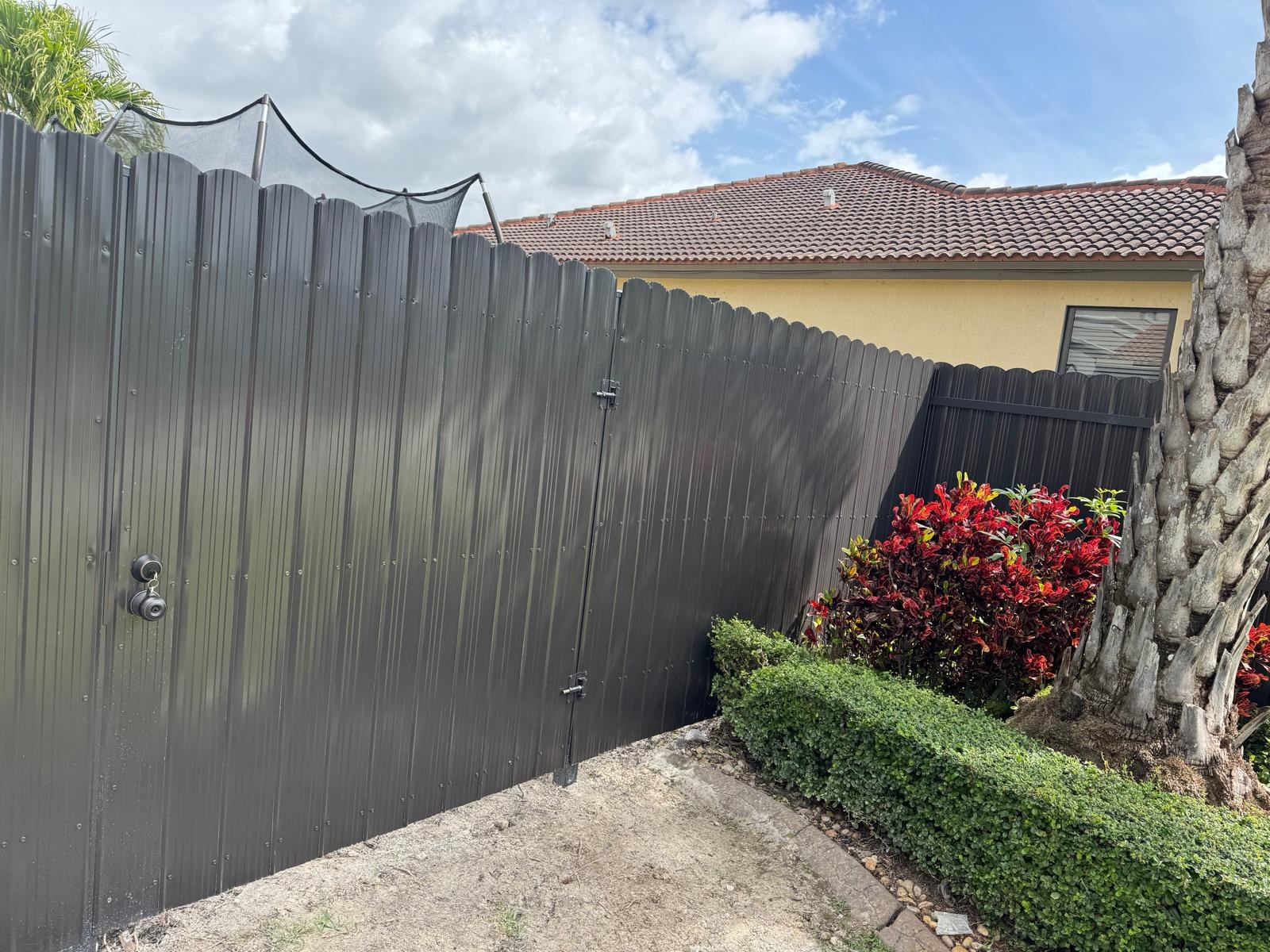 Gate and fence beside a landscaped walkway