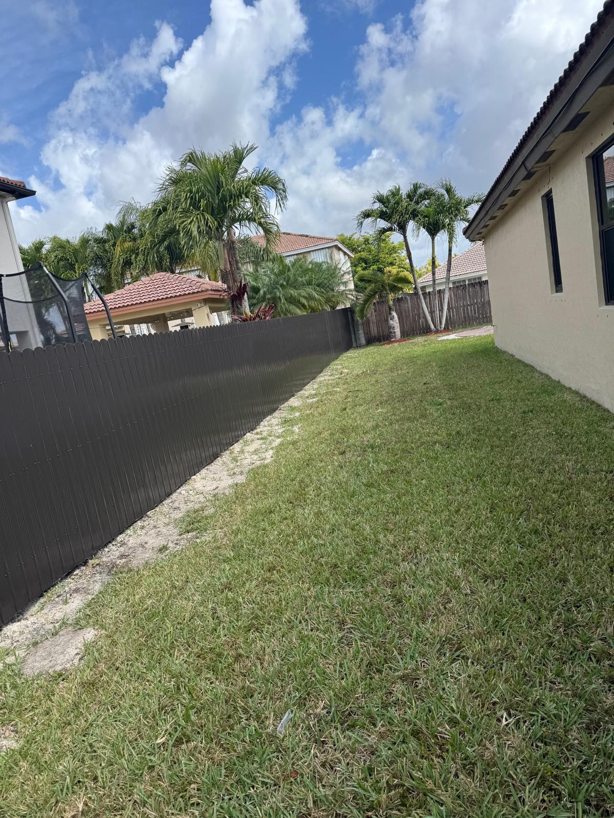 Fence bordering a grassy side yard